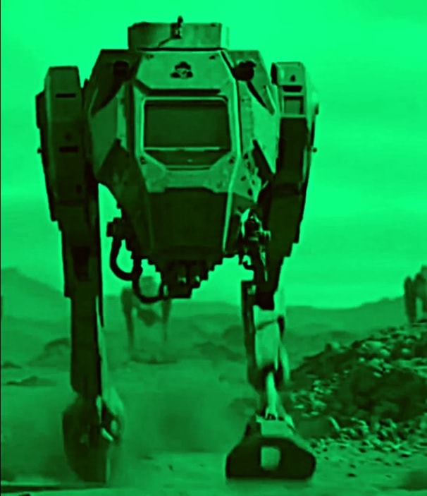 A trotter war machine advances across rocky terrain